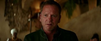 Movie still from “Zoolander 2” (2016), directed by Ben Stiller – A person wearing a green jacket; Close Up shot, Over the shoulder angle