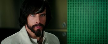 Movie still from “Zoolander 2” (2016), directed by Ben Stiller – A person with long hair and a beard; Close Up shot, Over the shoulder angle