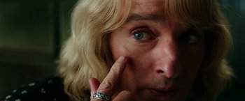 Movie still from “Zoolander 2” (2016), directed by Ben Stiller – A person with a finger on their face; Extreme Close Up shot, Overhead angle