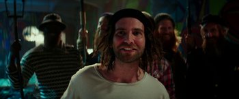 Movie still from “Zoolander 2” (2016), directed by Ben Stiller – A man with dreads is smiling for the camera; Close Up shot, Low angle