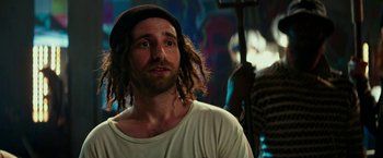 Movie still from “Zoolander 2” (2016), directed by Ben Stiller – A man with dreads is looking at the camera; Close Up shot, Over the shoulder angle