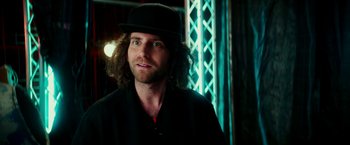 Movie still from “Zoolander 2” (2016), directed by Ben Stiller – A man with long hair wearing a black hat; Close Up shot, Low angle