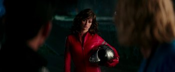 Movie still from “Zoolander 2” (2016), directed by Ben Stiller – A woman in a red outfit holding a helmet; Close Up shot, Over the shoulder angle