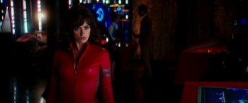 Movie still from “Zoolander 2” (2016), directed by Ben Stiller – A woman in a red jacket standing in a room; Medium shot, Over the shoulder angle