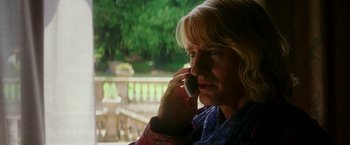 Movie still from “Zoolander 2” (2016), directed by Ben Stiller – A woman talking on a cell phone while sitting outside; Close Up shot, Over the shoulder angle