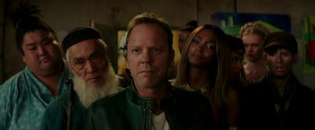 Movie still from “Zoolander 2” (2016), directed by Ben Stiller – A group of people standing next to each other in a room; Close Up shot, Over the shoulder angle