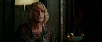 Movie still from “Zoolander 2” (2016), directed by Ben Stiller – A man with blonde long hair and tattoos; Close Up shot, Over the shoulder angle