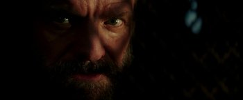 Movie still from “Zoolander 2” (2016), directed by Ben Stiller – A man with a beard looking at the camera; Extreme Close Up shot, Low angle