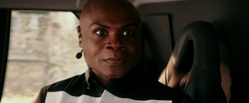 Movie still from “Zoolander 2” (2016), directed by Ben Stiller – A man with a surprised look on his face; Close Up shot, Over the shoulder angle