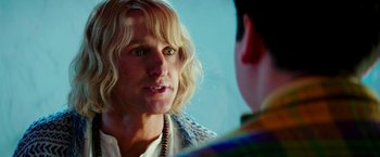 Movie still from “Zoolander 2” (2016), directed by Ben Stiller – A man with long blonde hair talking to another man; Close Up shot, Over the shoulder angle
