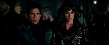 Movie still from “Zoolander 2” (2016), directed by Ben Stiller – A man and a woman standing next to each other in a dark room; Close Up shot, Over the shoulder angle