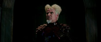 Movie still from “Zoolander 2” (2016), directed by Ben Stiller – A man with a beard and a wig on his head; Close Up shot, Over the shoulder angle