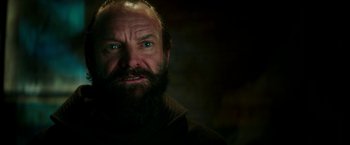 Movie still from “Zoolander 2” (2016), directed by Ben Stiller – A man with a goatee and a beard stares at the camera; Close Up shot, Low angle