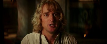 Movie still from “Zoolander 2” (2016), directed by Ben Stiller – A person with long blonde hair; Close Up shot, Over the shoulder angle