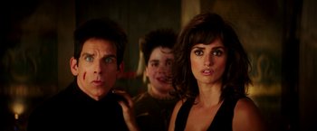 Movie still from “Zoolander 2” (2016), directed by Ben Stiller – A man and two women standing next to each other in a room; Close Up shot, Over the shoulder angle