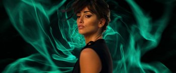 Movie still from “Zoolander 2” (2016), directed by Ben Stiller – A woman in a black dress with green smoke behind her; Close Up shot, Low angle