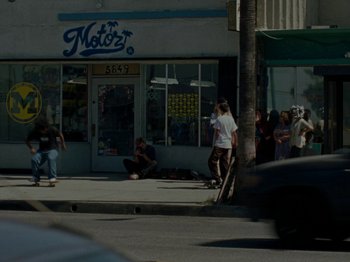 Movie still from “Mid90s” (2018), directed by Jonah Hill – A group of skateboarders on the sidewalk in front of a store; Wide shot, High angle