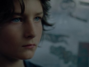 Movie still from “Mid90s” (2018), directed by Jonah Hill – A person with blue eyes; Extreme Close Up shot, Over the shoulder angle