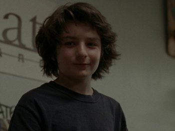 Movie still from “Mid90s” (2018), directed by Jonah Hill – A young boy is smiling for the camera; Close Up shot, Low angle