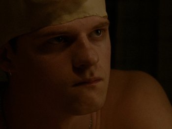 Movie still from “Mid90s” (2018), directed by Jonah Hill – A person with a hat on his head; Close Up shot, Over the shoulder angle