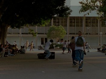 Movie still from “Mid90s” (2018), directed by Jonah Hill – A group of skateboarders riding down a sidewalk; Extreme Wide shot, High angle