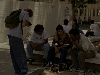 Movie still from “Mid90s” (2018), directed by Jonah Hill – A group of young men sitting next to each other on a bench; Wide shot, High angle