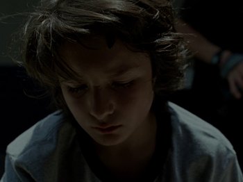 Movie still from “Mid90s” (2018), directed by Jonah Hill – A young boy is looking down at his face; Close Up shot, Low angle