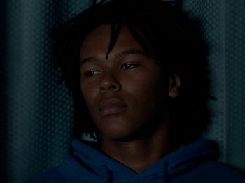 Movie still from “Mid90s” (2018), directed by Jonah Hill – A man with dreadlocks is looking at the camera; Close Up shot, Low angle