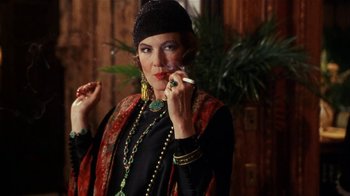 Movie still from “Bullets Over Broadway” (1994), directed by Woody Allen – A woman smoking a cigarette while wearing a hat; Close Up shot, Low angle