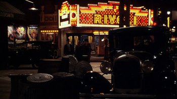 Movie still from “Bullets Over Broadway” (1994), directed by Woody Allen – A row of cars parked on the side of the street; Wide shot, High angle