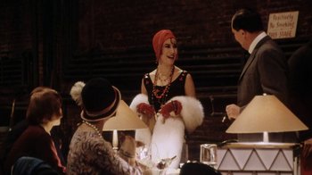 Movie still from “Bullets Over Broadway” (1994), directed by Woody Allen – A group of people sitting around a table; Medium shot, Over the shoulder angle