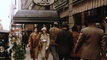 Movie still from “Bullets Over Broadway” (1994), directed by Woody Allen – A group of people walking down a street; Wide shot, Over the shoulder angle