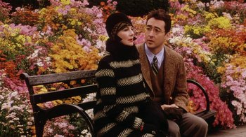 Movie still from “Bullets Over Broadway” (1994), directed by Woody Allen – A man and a woman sitting on a park bench; Medium shot, High angle