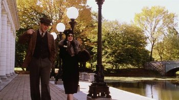 Movie still from “Bullets Over Broadway” (1994), directed by Woody Allen – An older woman and a young man walking on a sidewalk; Wide shot, Low angle