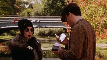 Movie still from “Bullets Over Broadway” (1994), directed by Woody Allen – A man and a woman are looking at their cell phones; Medium shot, Over the shoulder angle
