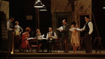 Movie still from “Bullets Over Broadway” (1994), directed by Woody Allen – A group of people sitting around a table; Wide shot, High angle