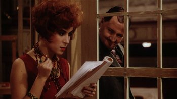 Movie still from “Bullets Over Broadway” (1994), directed by Woody Allen – A man and a woman looking at papers in front of a window; Close Up shot, Over the shoulder angle