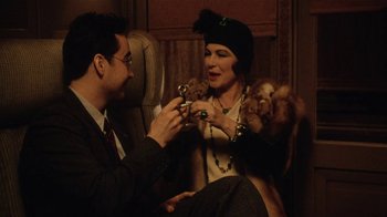 Movie still from “Bullets Over Broadway” (1994), directed by Woody Allen – A man and a woman sitting on a chair; Medium shot, High angle