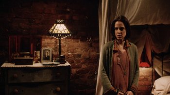 A woman standing next to a table in a room