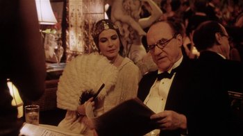 Movie still from “Bullets Over Broadway” (1994), directed by Woody Allen – An older man and a young woman dressed in 1 9 2 0's fashion; Medium shot, Over the shoulder angle