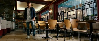 Movie still from “xXx: Return of Xander Cage” (2017), directed by D.J. Caruso – A man standing in front of a table in a restaurant; Wide shot, Low angle