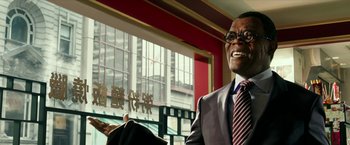 Movie still from “xXx: Return of Xander Cage” (2017), directed by D.J. Caruso – A man wearing a suit and tie smiling; Close Up shot, Low angle