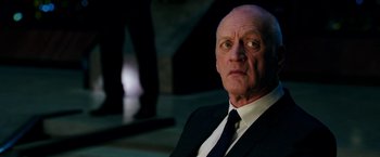Movie still from “xXx: Return of Xander Cage” (2017), directed by D.J. Caruso – An older man wearing a suit and tie; Close Up shot, Low angle