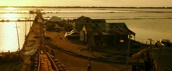 Movie still from “xXx: Return of Xander Cage” (2017), directed by D.J. Caruso – People walking on the tracks near a body of water; Extreme Wide shot, High angle