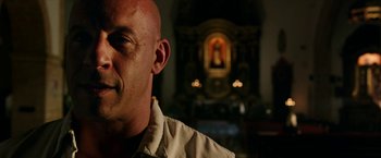 Movie still from “xXx: Return of Xander Cage” (2017), directed by D.J. Caruso – A man with bald head looking into the distance; Close Up shot, Over the shoulder angle