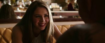 Movie still from “xXx: Return of Xander Cage” (2017), directed by D.J. Caruso – A beautiful young lady sitting on top of a yellow couch; Close Up shot, Over the shoulder angle