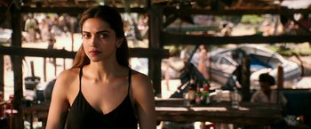 Movie still from “xXx: Return of Xander Cage” (2017), directed by D.J. Caruso – A beautiful young lady wearing a black top; Close Up shot, Over the shoulder angle
