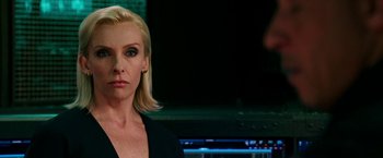 Movie still from “xXx: Return of Xander Cage” (2017), directed by D.J. Caruso – A woman in a black shirt is standing in front of a computer screen; Close Up shot, Over the shoulder angle