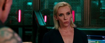 Movie still from “xXx: Return of Xander Cage” (2017), directed by D.J. Caruso – A woman with blonde hair is standing in front of neon lights; Close Up shot, Over the shoulder angle