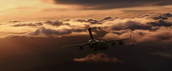 Movie still from “xXx: Return of Xander Cage” (2017), directed by D.J. Caruso – An airplane is flying through the sky at sunset; Extreme Wide shot, Low angle